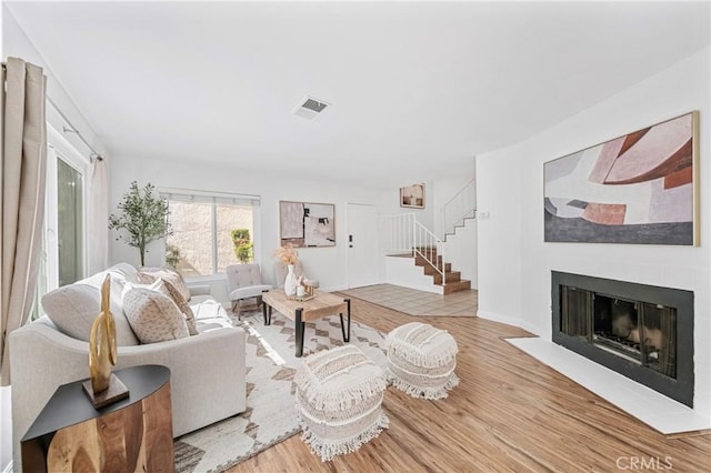 23640 Monument Canyon Dr Unit C, Diamond Bar, CA 91765 - living area featuring wood finished floors, stairway, and a fireplace with flush hearth