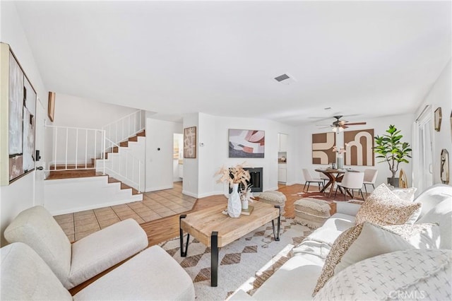 23640 Monument Canyon Dr Unit C, Diamond Bar, CA 91765 - living room featuring a ceiling fan, stairway, and a fireplace