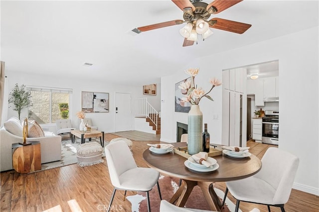 23640 Monument Canyon Dr Unit C, Diamond Bar, CA 91765 - dining room featuring stairway, a ceiling fan, and light wood-style floors
