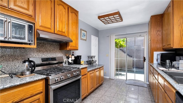2116 Marine Ave, Gardena, CA 90249 - kitchen featuring appliances with stainless steel finishes, under cabinet range hood, tasteful backsplash, brown cabinets, and granite tiled floors