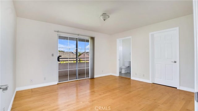 2116 Marine Ave, Gardena, CA 90249 - unfurnished bedroom featuring light wood-style floors, access to exterior, and connected bathroom