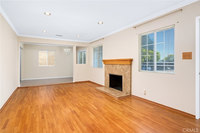 2116 Marine Ave, Gardena, CA 90249 - unfurnished living room featuring light wood-type flooring, a chandelier, crown molding, a high end fireplace, and recessed lighting