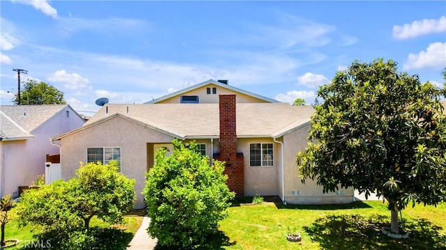2116 Marine Ave, Gardena, CA 90249 - back of property featuring stucco siding, a lawn, and a chimney