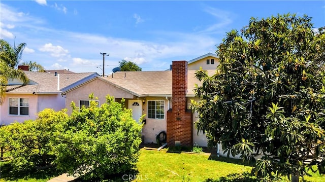 2116 Marine Ave, Gardena, CA 90249 - view of front of property with stucco siding, a front lawn, a chimney, and roof with shingles
