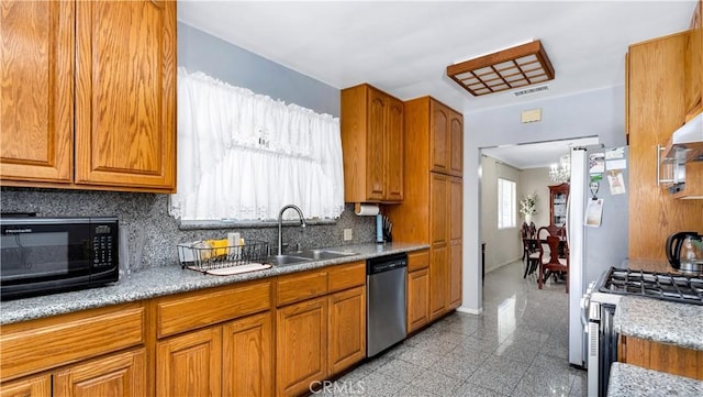 2116 Marine Ave, Gardena, CA 90249 - kitchen with appliances with stainless steel finishes, backsplash, granite tiled floors, a chandelier, and brown cabinetry