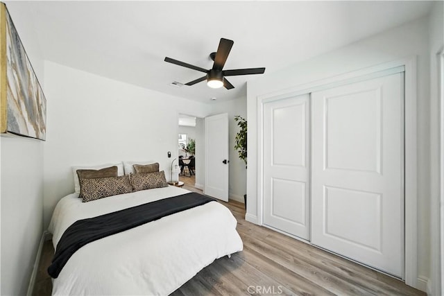 5243 Tara Pl, San Diego, CA 92117 - bedroom with light wood-type flooring, a closet, and a ceiling fan