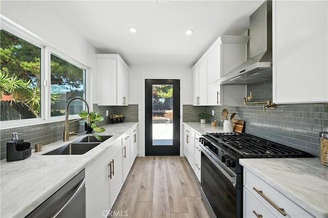 5243 Tara Pl, San Diego, CA 92117 - kitchen with range with gas stovetop, wall chimney range hood, stainless steel dishwasher, decorative backsplash, and white cabinets
