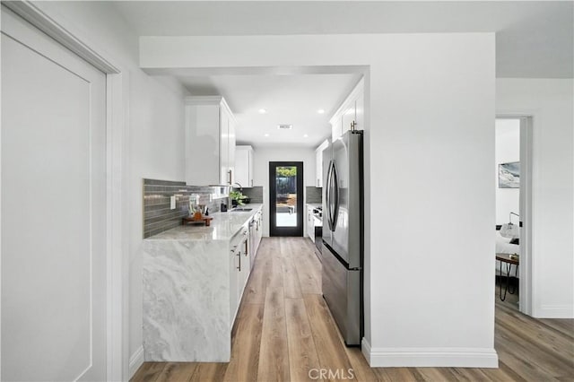 5243 Tara Pl, San Diego, CA 92117 - kitchen with stainless steel fridge with ice dispenser, white cabinetry, light wood-style flooring, backsplash, and recessed lighting