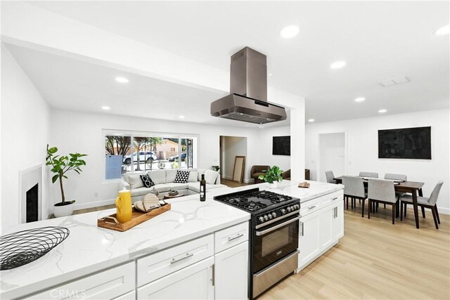 1170 Turquoise St, Hemet, CA 92543 - kitchen with stainless steel range with gas stovetop, ventilation hood, open floor plan, light stone countertops, and recessed lighting