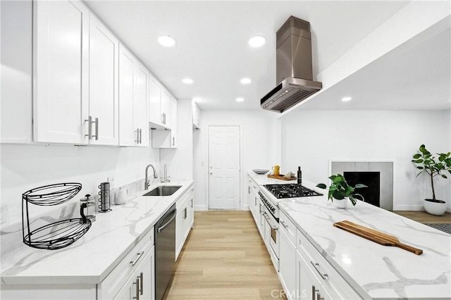 1170 Turquoise St, Hemet, CA 92543 - kitchen with wall chimney exhaust hood, stainless steel dishwasher, light wood finished floors, recessed lighting, and white cabinetry