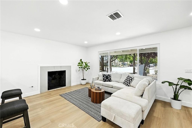 1170 Turquoise St, Hemet, CA 92543 - living room with a fireplace, light wood-style flooring, and recessed lighting