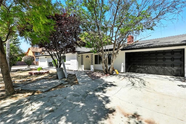1170 Turquoise St, Hemet, CA 92543 - view of front of home featuring a chimney, a garage, driveway, and stucco siding