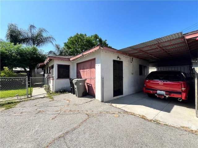 3855 Maine Ave, Baldwin Park, CA 91706 - garage featuring a gate and a carport