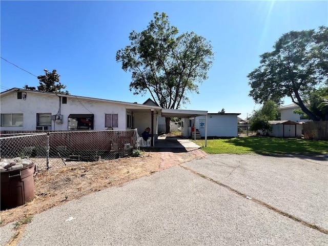 3855 Maine Ave, Baldwin Park, CA 91706 - view of front of property featuring a storage shed, stucco siding, asphalt driveway, and an attached carport