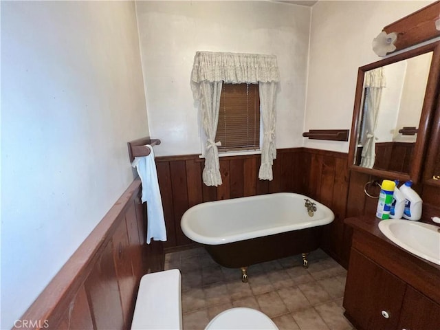 3855 Maine Ave, Baldwin Park, CA 91706 - full bathroom featuring a wainscoted wall, vanity, a freestanding bath, tile patterned floors, and wooden walls