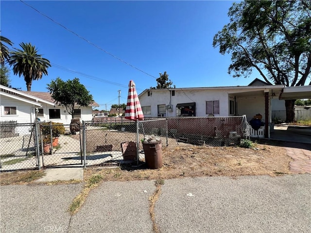 3855 Maine Ave, Baldwin Park, CA 91706 - view of front of home with stucco siding, a fenced front yard, and a gate