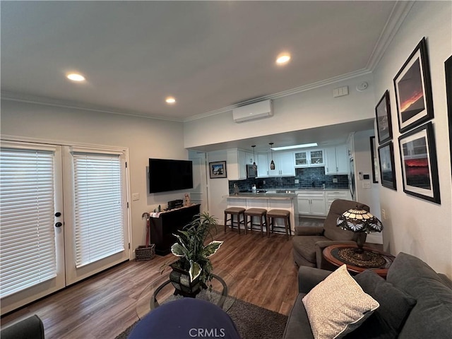 1501 Pelham Unit 127F, Seal Beach, CA 90740 - living room featuring a wall mounted AC, crown molding, wood finished floors, french doors, and recessed lighting