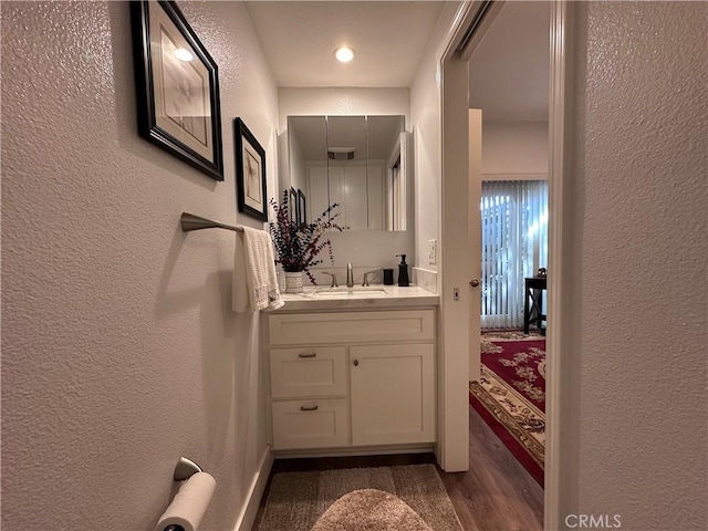 1501 Pelham Unit 127F, Seal Beach, CA 90740 - bathroom with a textured wall, vanity, and wood finished floors