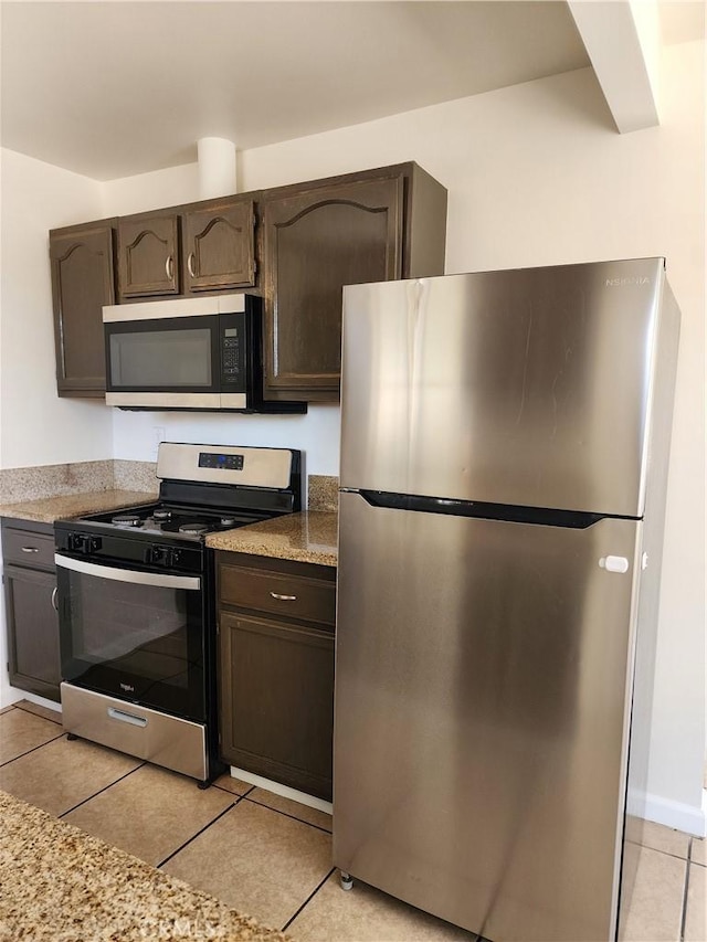 38638 Glenraven Ave, Palmdale, CA 93550 - kitchen featuring stainless steel appliances, light tile patterned flooring, and dark brown cabinetry