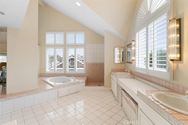 25912 Densmore Dr, Lake Forest, CA 92630 - bathroom featuring vanity, tile patterned flooring, a garden tub, a tile shower, and high vaulted ceiling