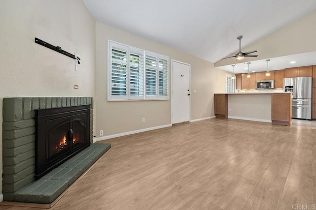 8350 Via Sonoma Unit A, La Jolla, CA 92037 - unfurnished living room with a fireplace, ceiling fan, vaulted ceiling, and light wood-style flooring