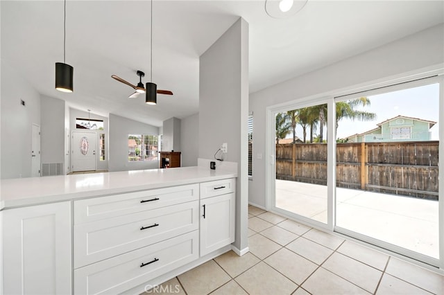 25671 Roylene Dr, Menifee, CA 92586 - kitchen featuring light tile patterned floors, lofted ceiling, white cabinets, light countertops, and a ceiling fan