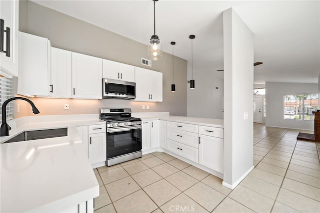 25671 Roylene Dr, Menifee, CA 92586 - kitchen featuring appliances with stainless steel finishes, light tile patterned floors, light countertops, and decorative light fixtures