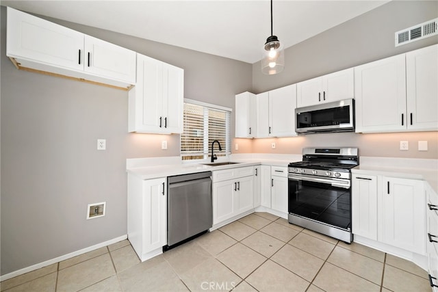 25671 Roylene Dr, Menifee, CA 92586 - kitchen featuring appliances with stainless steel finishes, light countertops, light tile patterned floors, and white cabinets