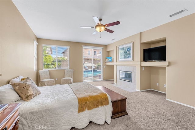 11567 Waterwell Ct, Riverside, CA 92505 - bedroom featuring carpet floors, a tiled fireplace, and ceiling fan