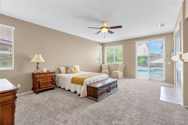 11567 Waterwell Ct, Riverside, CA 92505 - carpeted bedroom featuring access to outside, a fireplace with flush hearth, and a ceiling fan