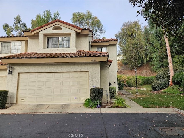1405 S Bodega Way Unit 1, Diamond Bar, CA 91765 - mediterranean / spanish-style home featuring a tiled roof, stucco siding, a garage, and concrete driveway