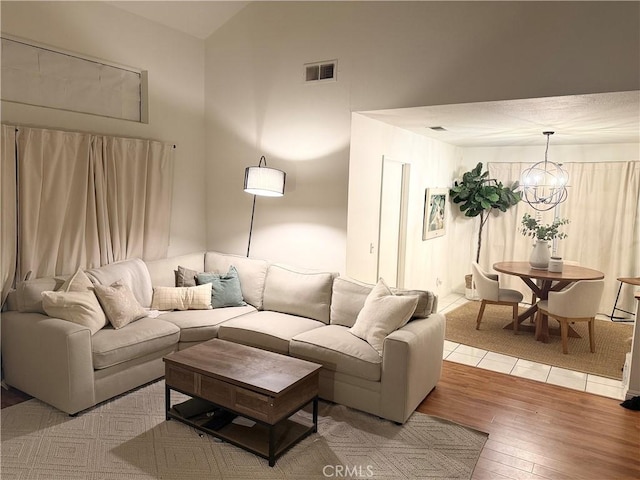 1405 S Bodega Way Unit 1, Diamond Bar, CA 91765 - living room featuring light wood finished floors, a chandelier, and vaulted ceiling