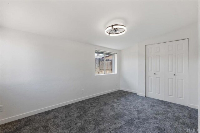 1327 Walbollen St, Spring Valley, CA 91977 - unfurnished bedroom featuring dark colored carpet, a closet, and vaulted ceiling