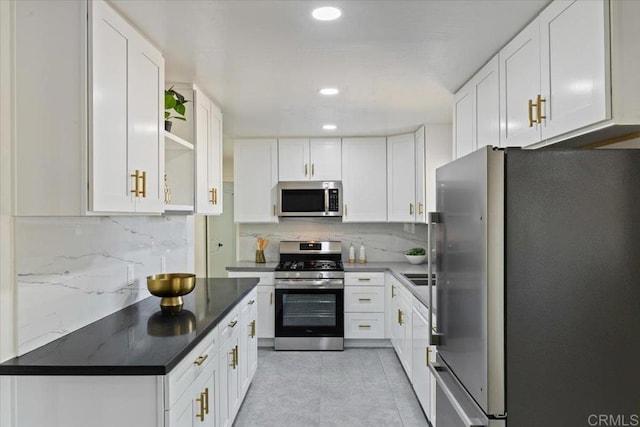 1327 Walbollen St, Spring Valley, CA 91977 - kitchen with appliances with stainless steel finishes, decorative backsplash, white cabinetry, dark countertops, and recessed lighting