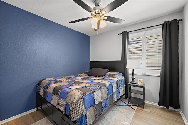 13220 February Dr, Corona, CA 92879 - bedroom with wood finished floors, a textured wall, and a ceiling fan
