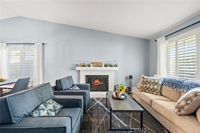 13220 February Dr, Corona, CA 92879 - living area featuring healthy amount of natural light, vaulted ceiling, and a fireplace