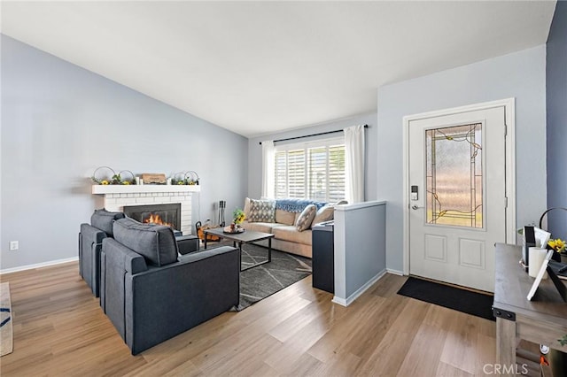 13220 February Dr, Corona, CA 92879 - living room featuring light wood finished floors and a fireplace