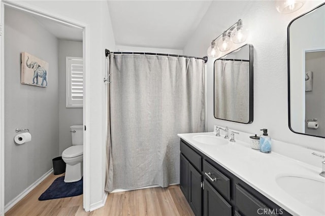13220 February Dr, Corona, CA 92879 - bathroom with wood finished floors, double vanity, and a shower with curtain