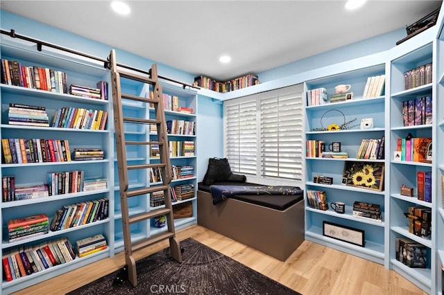 13220 February Dr, Corona, CA 92879 - sitting room with wood finished floors, bookshelves, and recessed lighting