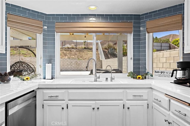 13220 February Dr, Corona, CA 92879 - kitchen featuring dishwasher, tile countertops, white cabinetry, and recessed lighting