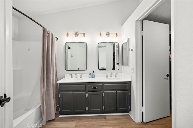 13220 February Dr, Corona, CA 92879 - full bath with double vanity, wood finished floors, and shower / bath combo with shower curtain