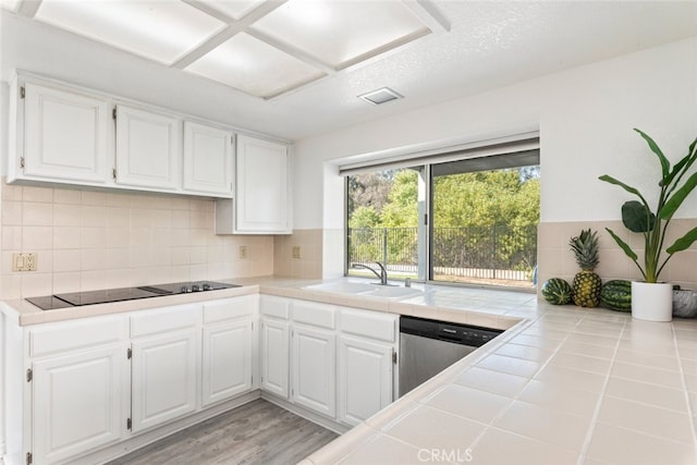 30611 Open Ct, Temecula, CA 92592 - kitchen with tile countertops, black electric stovetop, dishwasher, white cabinetry, and tasteful backsplash