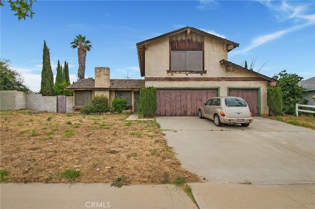 847 N Idyllwild Ave, Rialto, CA 92376 - view of front of house featuring driveway, a garage, and a chimney