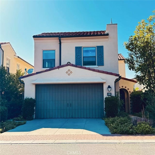 103 Alumroot, Irvine, CA 92620 - mediterranean / spanish-style house featuring a tile roof, driveway, and stucco siding