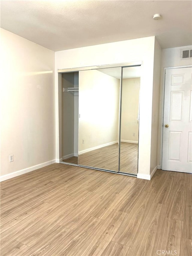 38710 10th St E Unit 12, Palmdale, CA 93550 - unfurnished bedroom with light wood-style flooring and a closet