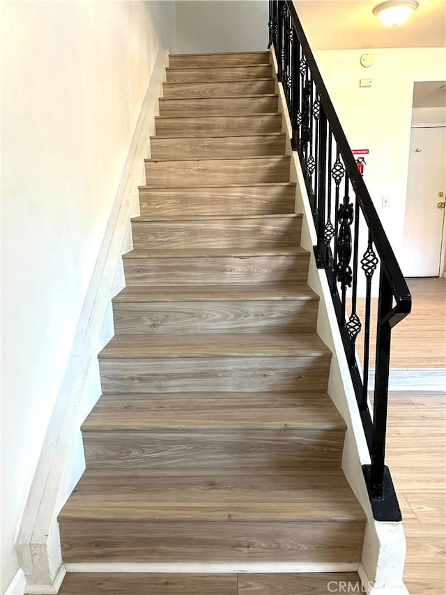 38710 10th St E Unit 12, Palmdale, CA 93550 - stairs featuring wood finished floors