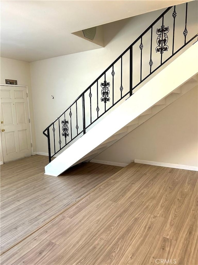 38710 10th St E Unit 12, Palmdale, CA 93550 - stairway featuring wood finished floors