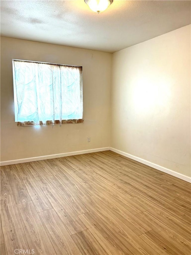 38710 10th St E Unit 12, Palmdale, CA 93550 - spare room featuring light wood-type flooring and a textured ceiling