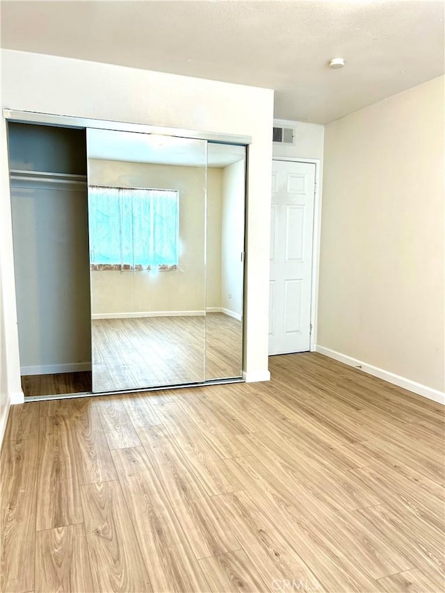 38710 10th St E Unit 12, Palmdale, CA 93550 - unfurnished bedroom featuring wood finished floors and baseboards