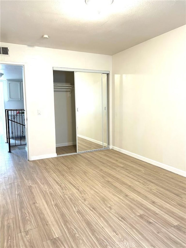 38710 10th St E Unit 12, Palmdale, CA 93550 - unfurnished bedroom with light wood-style flooring and a closet